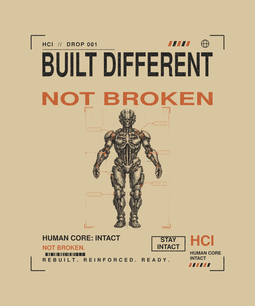 Built Different tee back print on sand — Human Core Intact Drop 001